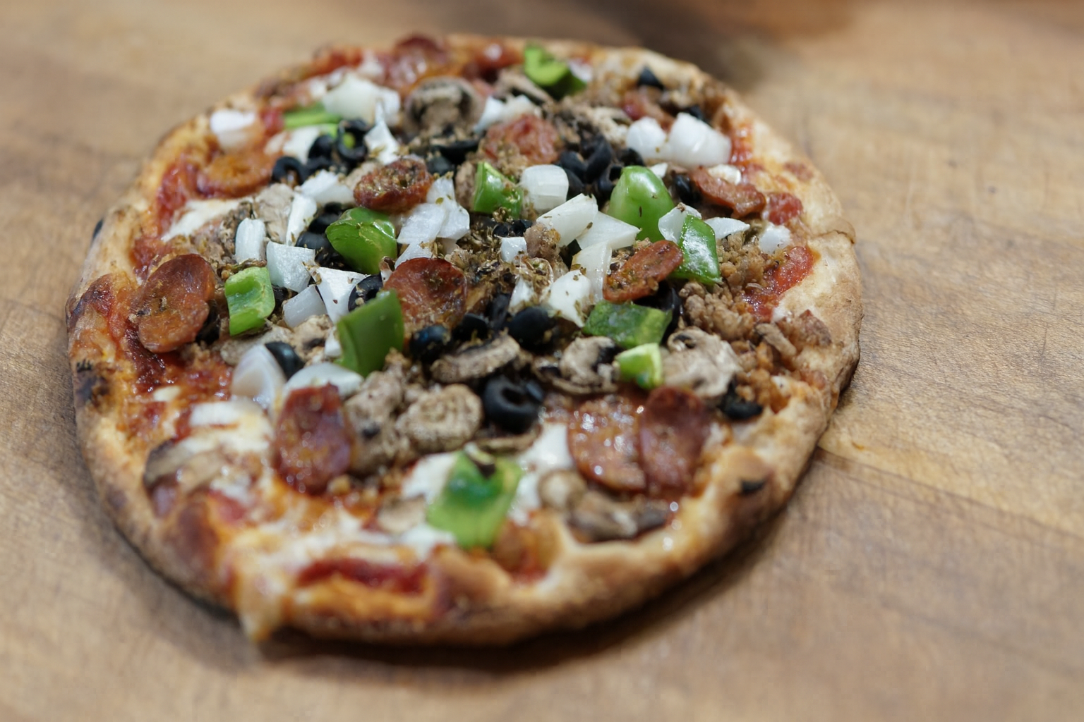 Table spread with pizzas, pasta, and Italian appetizers